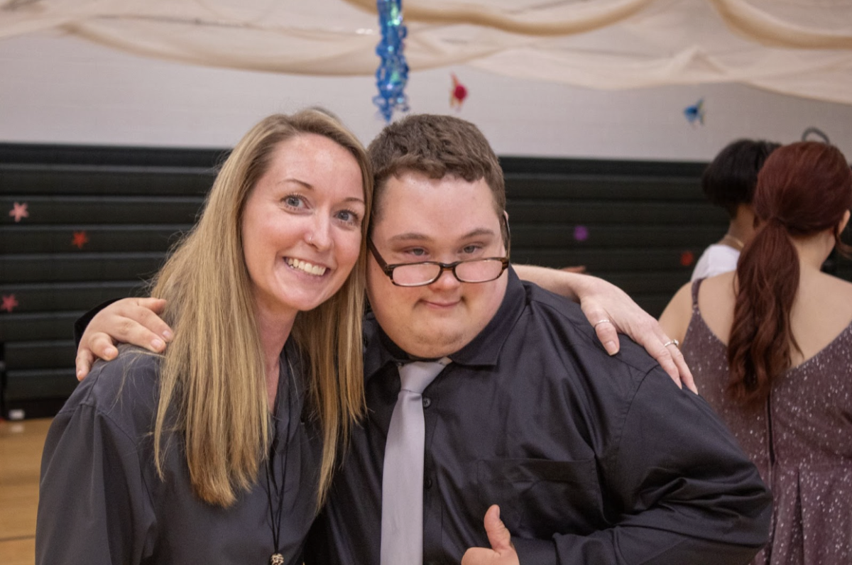 Attendance assistant Charity Boston hugs Dustin Talley.